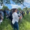 People outside listening to a speaker
